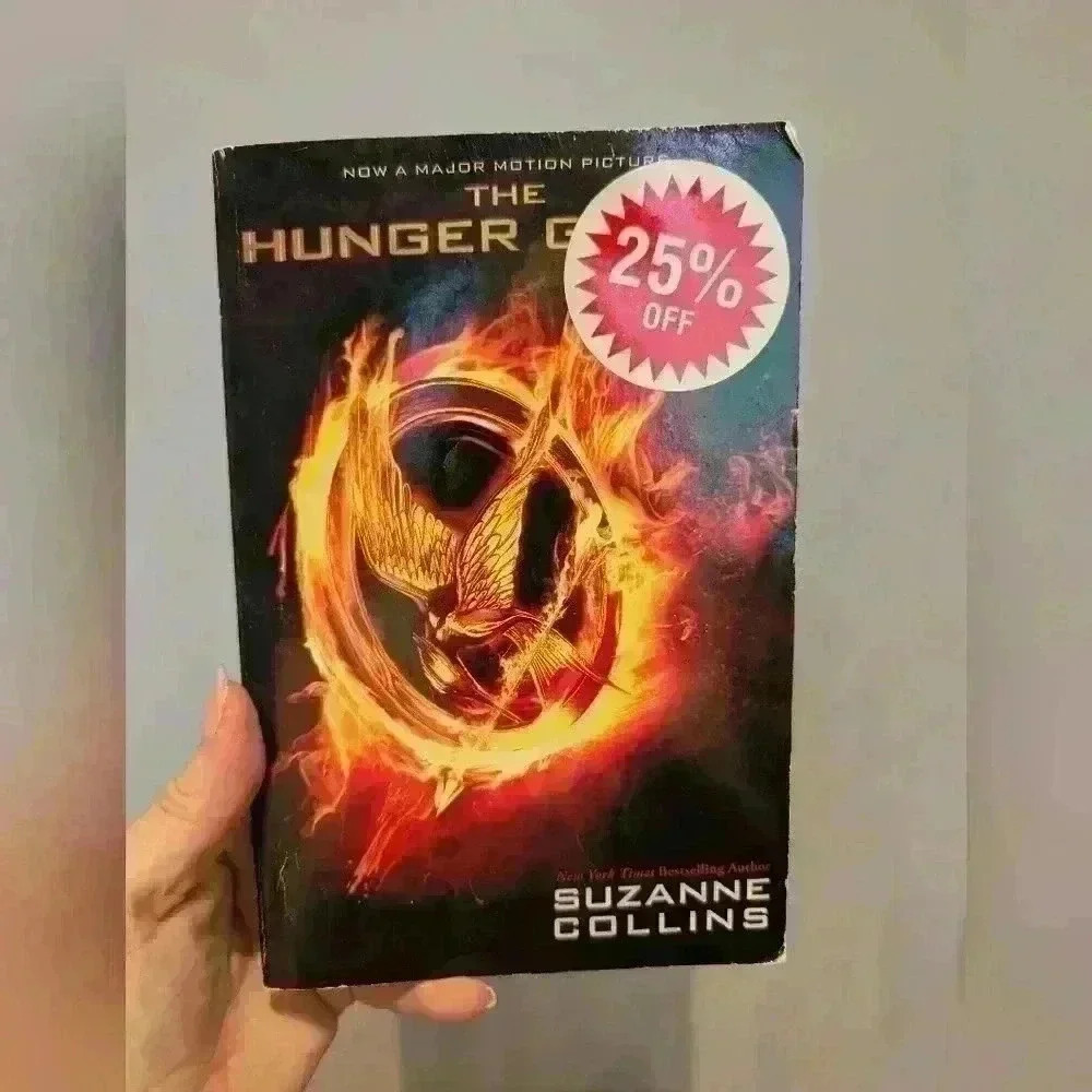 Paperback hunger games  book by Suzanne collins